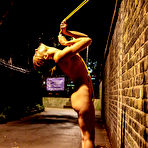 First pic of Naked teen is restrained to a brick wall with yellow rope at night