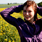 First pic of Redheaded teen pauses for a moment before getting naked in a field of crops