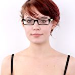 Second pic of Nerdy redhead wears a mischievous smile while getting naked for the first time