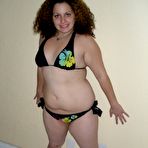 Third pic of Fat woman with pierced nipples toys her bald twat before donning a bikini