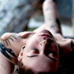 Second pic of Tattooed female Cutz sports dreadlocks while showing her tiny tits