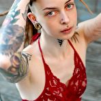Third pic of Tattooed female Cutz sports dreadlocks while showing her tiny tits