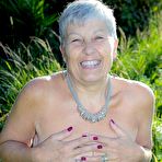 Second pic of Silver haired granny Savana gets naked outdoors on a blanket in stockings