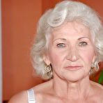 First pic of Lustful granny in white stockings masturbating her twat with a big dildo