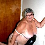 Fourth pic of Obese nan Grandma Libby parts her shaved pussy after removing satin underwear