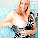 First pic of Middle-aged lady Tonya gets naked on top of her bed in heels