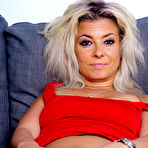 Second pic of Dirty blonde Alana removes a red dress before dildoing her pussy on a sofa
