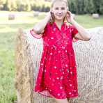 First pic of Young natural blonde Beti gets bare naked against a round hay bale in a field