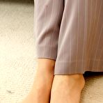 Fourth pic of Blonde female Chacha shows her hose clad feet in a business suit