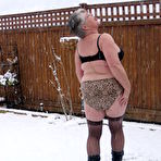 Third pic of Naughty granny Girdle Goddess strips to her stockings and boots while it snows