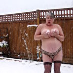 Fourth pic of Naughty granny Girdle Goddess strips to her stockings and boots while it snows