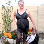 Third pic of Fat nan Girdle Goddess sets her saggy boobs free of a girdle in the backyard