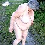 Second pic of Fat nan Grandma Libby steps into a puddle before covering herself in mud