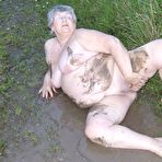 Third pic of Fat nan Grandma Libby steps into a puddle before covering herself in mud