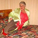 First pic of Fat granny Girdle Goddess pets her pussy after stripping to hosiery on her bed