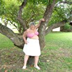 Third pic of Obese British lady Grandma Libby exposes her large tits underneath a tree