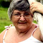 Fourth pic of Old British woman Grandma Libby exposes her boobs on a backyard bench swing