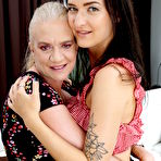 First pic of Old and young lesbians kiss before getting naked for sex on a sofa