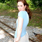 Second pic of Pale redhead uncovers her small boobs near model railroad tracks