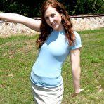 Third pic of Pale redhead uncovers her small boobs near model railroad tracks