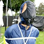 Third pic of White girl is left tied up in rainwear with her panties stuffed in her mouth