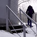 Fourth pic of White girl pulls down her jeans to pee in the snow behind a building