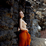 First pic of Young brunette Keira Blue models completely naked against a rock face