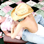 Fourth pic of Young lesbians play with each others boobs while wearing blue jeans