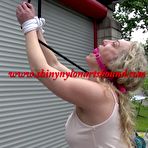 Fourth pic of Shinynylonartsbound | SOPHIE wearing sexy shiny nylon shorts and a top being tied and gagged overhead with ropes and a ballgag (Video)